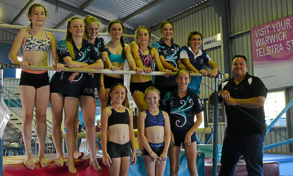EXPANDING HORIZONS: Gymnasts (back) Ella Murphy, Demi Eather, Lillie Clarke, Shaye Campbell, Amber Hentschel, Lara Walker, Imogene Davidson (front) Steph Lyons, Mikayla O’Neill and Christie Lyons and president Coby Walker welcome a Queensland Government grant to build a new shed.